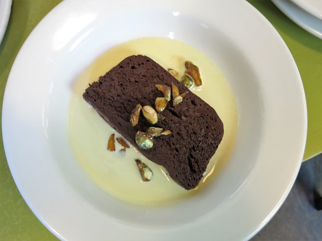Dense chocolate mousse terrine with pistachio creme anglais and candied pistachios.