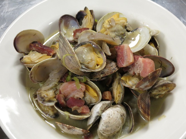 Penn Cove clams sauteed with house made smoked ventreche, leeks, fennel and charred leek fumet.