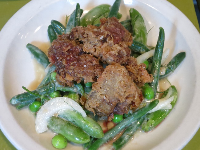Butter milk fried chicken livers on a salad of green beans, snow peas, peas and roasted shallot dressing