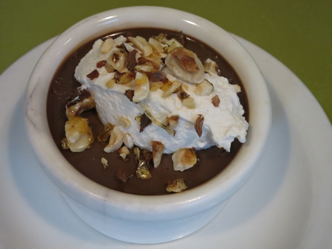 Chocolate pots de creme with coffee whipped cream and candied hazelnuts