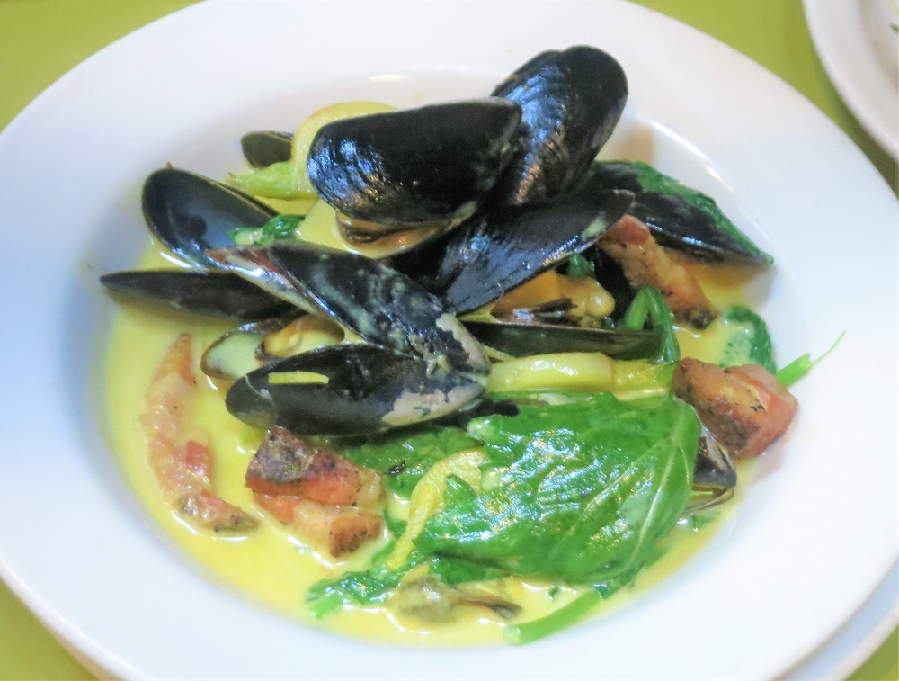 Penn Cove mussels sauteeed with house made pancetta, turnips, turnip greens and creamy saffron fumet